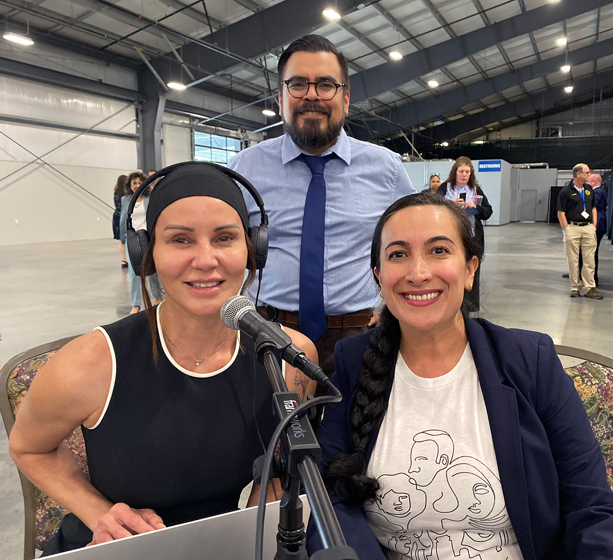 Two TLC interpreters sit with TLC's director of interpretation and translation at an interpretation event.