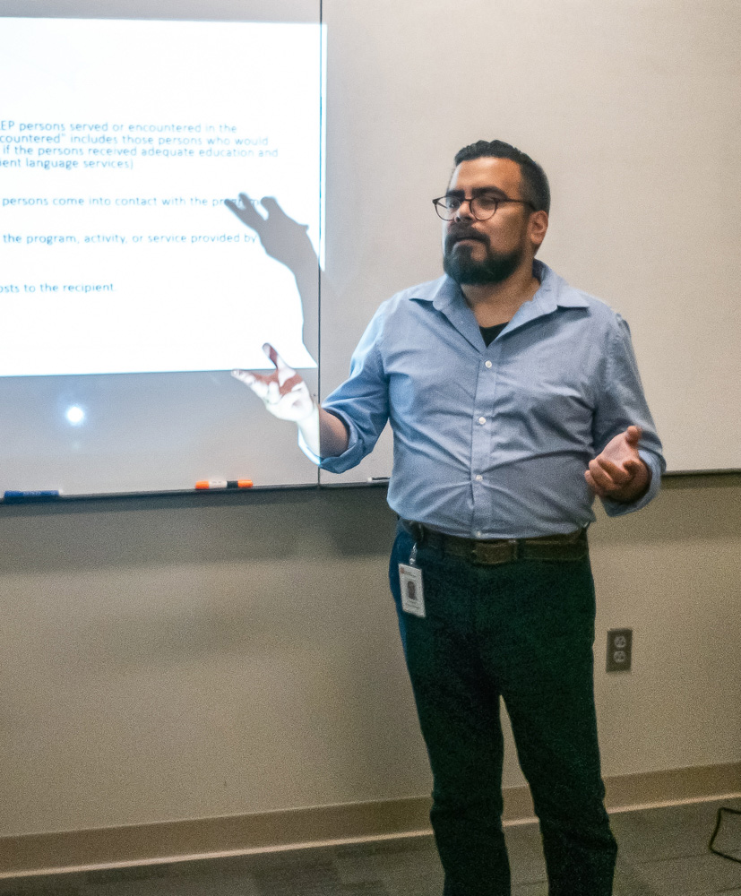 Richard Ponce de Leon presents a language access plan to a company.