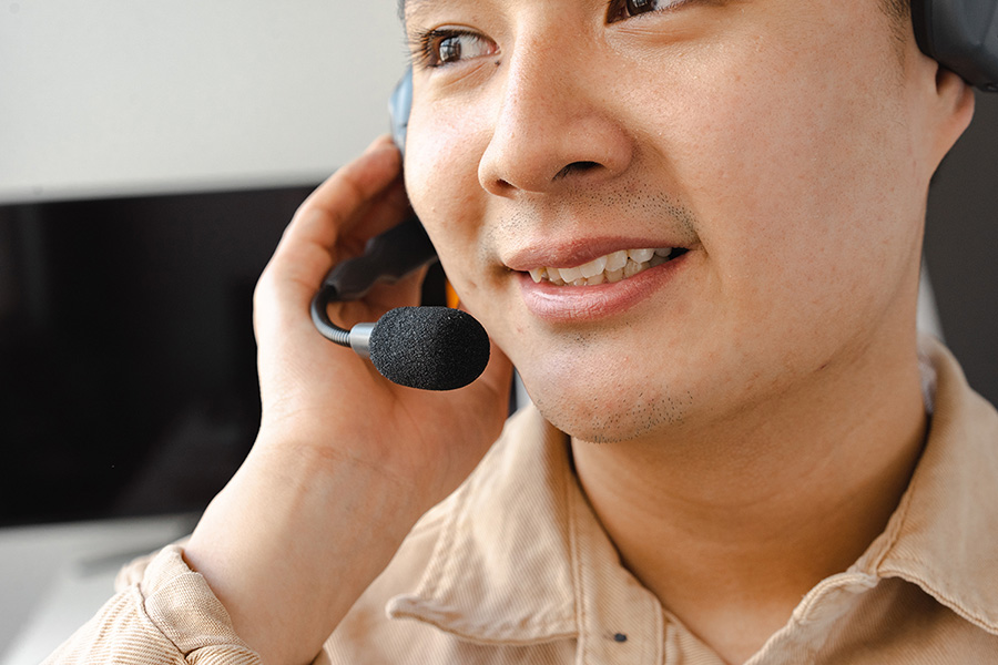 A man speaks into a headset microphone.