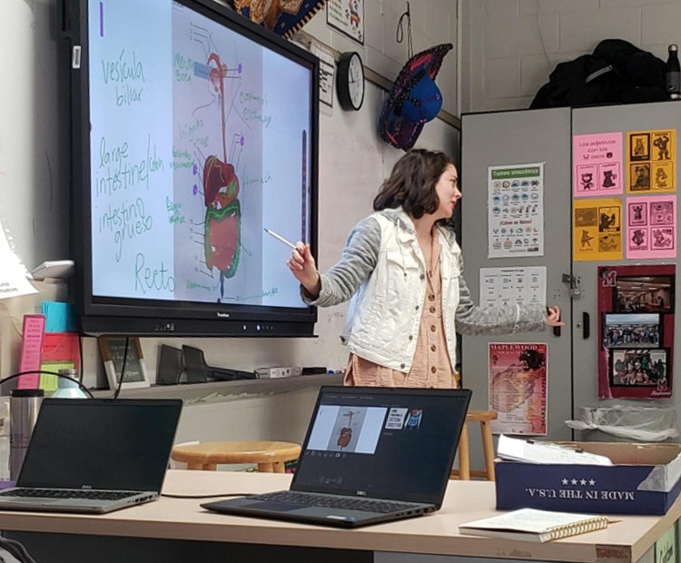 TLC's Genna Linton stands at a whiteboard and teaches a Medial Interpreter Trainng course at Maplewood High School.