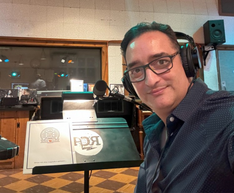 TLC's Mauricio Lopera sits in a recording booth and translates an audio tour at the Country Music Hall of Fame.