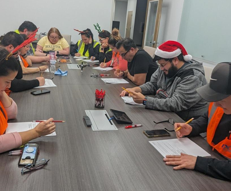 People sitting around a table taking a written test