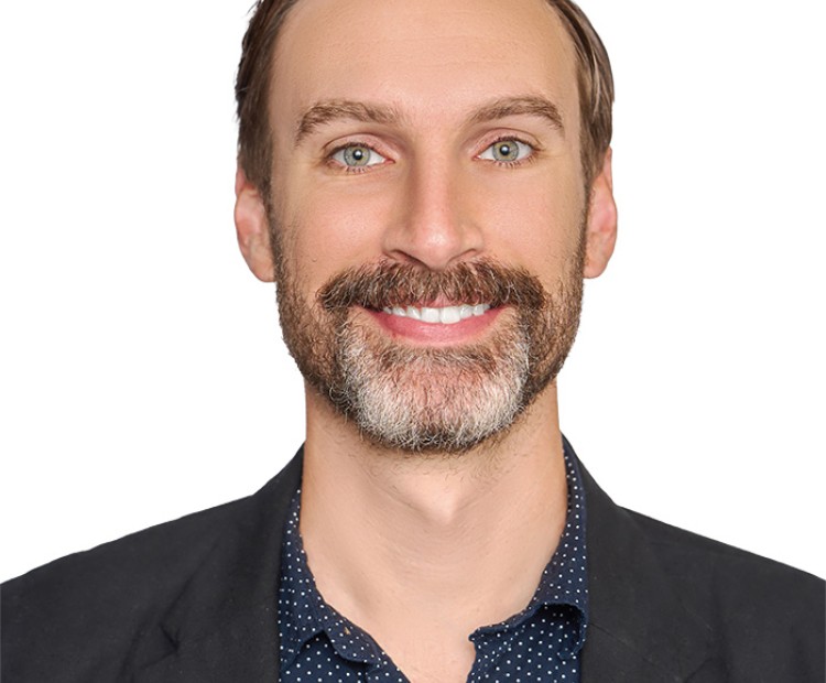 Headshot of a man with a beard and moustache
