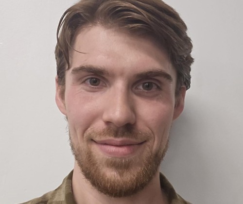 Headshot of a man with a beard and moustache