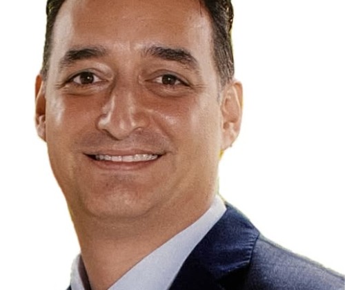 Headshot of a man wearing a suit and tie