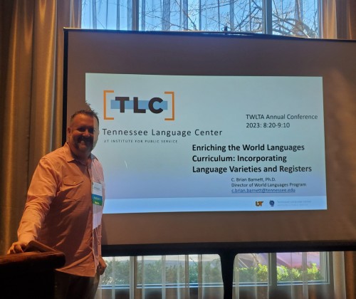 TLC's Brian Barnett standing in front of a screen with a PowerPoint slide