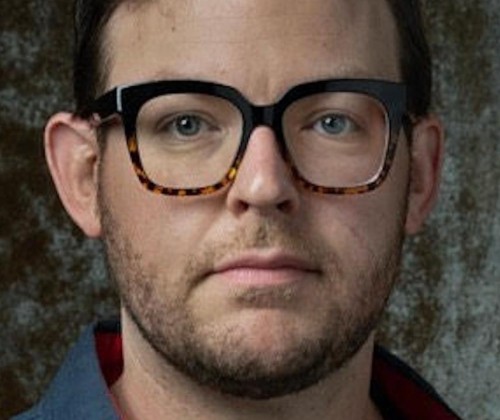 Headshot of a man wearing glasses. 