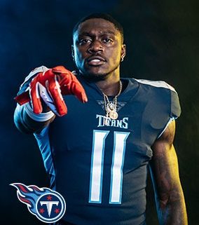 Titans player in pads and uniform pointing at viewer