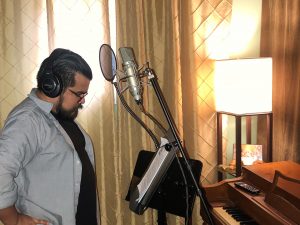 Man doing voiceover in sound studio in front of microphones