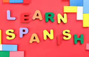 Foam letters spell out Learn Spanish on a red background