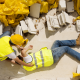 Construction worker laying on ground after falling
