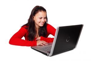 Woman sitting at laptop computer for Help Desk