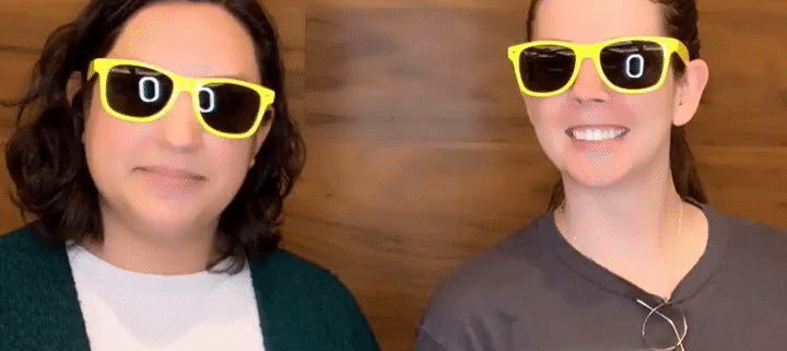 Two women wearing yellow rimmed sunglasses