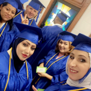 Group of women in blue graduation cap and gowns