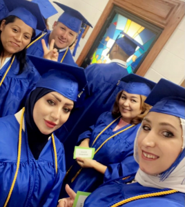 Group of women in blue graduation cap and gowns