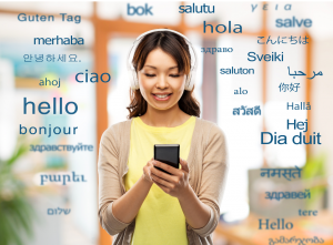 Woman in yellow shirt looking at cell phone in her hands while greetings in various languages float around her 