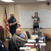 Woman standing at whiteboard teaching