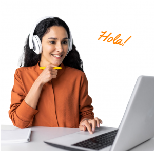 Woman in headphones in front of a laptop learning Spanish