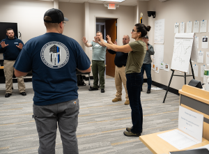 Woman and officers standing in Spanish class